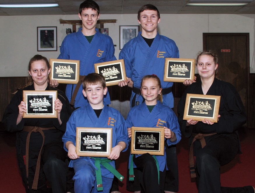 Above, members of Huard’s Sport Karate team captured 2016 state championship titles on December 3 at the SMART Rating Championships. Front row, from left to right, Theresa Lamanteer, Austin Lizotte, Abby Dudley and Traci Lamanteer. Back, Tyler Bard and Kayle Anderson. In photo below, Mikayla Achorn, right, also a member of the team is pictured with Sensei Mark Huard. She captured titles in both forms and fighting. Photos courtesy of Mark Huard, owner Central Maine Photography