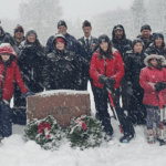 PHOTO: Local scouts clear cemetery markers of snow